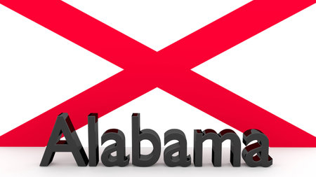 Writing with the name of the US state Alabama made of dark metal  in front of state flagの写真素材