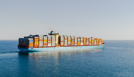 Suez Canal, Egypt-November 5, 2017: Maersk line Suez Canal, sun set. GEORG MAERSK is registered and sailing under the flag of Denmark, her gross tonnage -98648 and deadweight is 115700のeditorial素材
