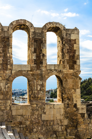 View from the Acropolis to the Ruins of the ancient theater Odeon of Herodes Atticus, in the background: modern buildings of Athens, Greeceの写真素材