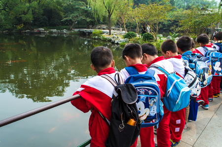 Hangzhou, China - October 24, 2013: Chinese school children in the Flower Harbor Park, West Lake, Hangzhou, Chinaのeditorial素材