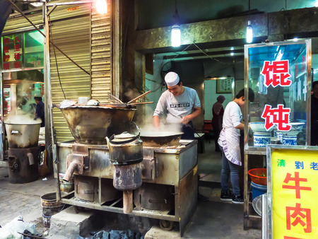 XIAN, CHINA - OCTOBER 17, 2013: Market street of Xian offer their customers various types of food stores, Shaanxi Province, Chinaのeditorial素材