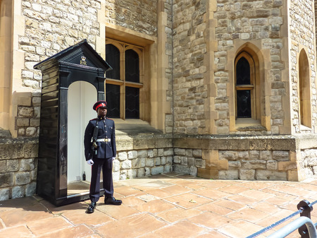 London, England â July 14, 2011: Palace guard in traditional national form with honor and dignity guarding the entrance to the vault of royal treasures, Tower of London, UK.のeditorial素材