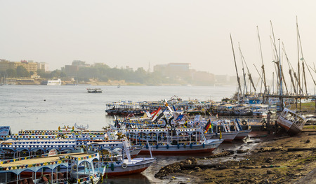 Luxor, Egypt - January 18, 2016: Tourist boats at pier on the east bank of the Nile, Luxor, Egypt. Luxor and the ruins of the temple complexes in Karnak - the largest open-air museum in the worldのeditorial素材