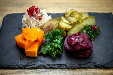 Plate of pickled vegetables with, pumpkin, beetroot, cucumber, cabbage and seasonal herbsの写真素材
