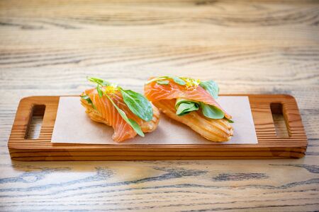 Salty ecler with fresh salmon on top and cheese insideの写真素材