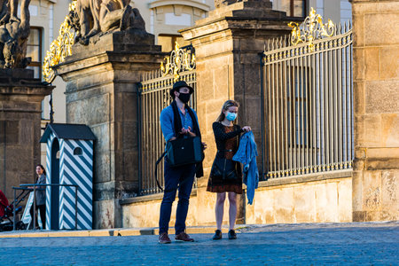 Prague, Czech republic - September 19, 2020. Tourists with face mask in front of the fence to the...
