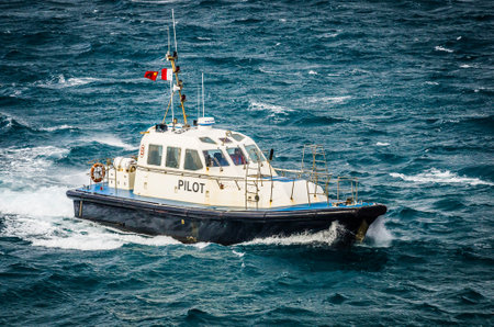 Tanger Med, Morocco - April 07, 2020. Security boat sailing in windy sea waves.のeditorial素材