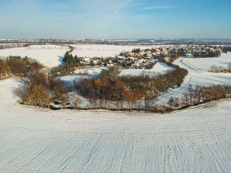 Aerial view of village in winter under snowの写真素材