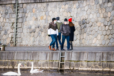 Prague, Czech republic - March 12. People wearing face mask protection on public places in riverbank Naplavka by Moldau riverのeditorial素材