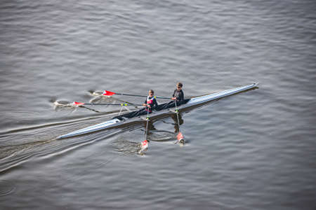Prague, Czech republic - February 24, 2021. Two young active people rowing in Moldau riverのeditorial素材