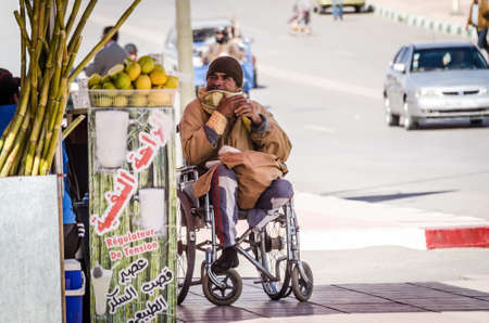 Errachidia, Morocco - April 11, 2015. Handicapped man without legs on wheelchairのeditorial素材