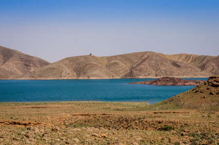 Turquoise blue water in Barrage Al-Hassan Addakhil in dry nature near Errachidia in Moroccoの写真素材