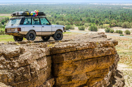 Erfoud, Morocco - April 15, 2015. Old vinage off road car on viewpoint on rock cliffのeditorial素材