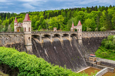 Czech republic, Talsperre Les Kralovstvi (Forest Kingdom) - May 15, 2021. Historic hydraulic water dam with orange water in river Elbeのeditorial素材