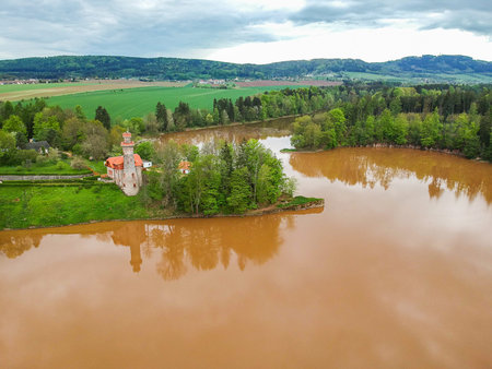 Czech republic, Talsperre Les Kralovstvi (Forest Kingdom) - May 15, 2021. Aerial view of historic hydraulic water dam with orange water in river Elbeのeditorial素材