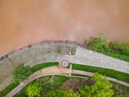 Czech republic, Talsperre Les Kralovstvi (Forest Kingdom) - May 15, 2021. Aerial view of historic hydraulic water dam with orange water in river Elbeのeditorial素材