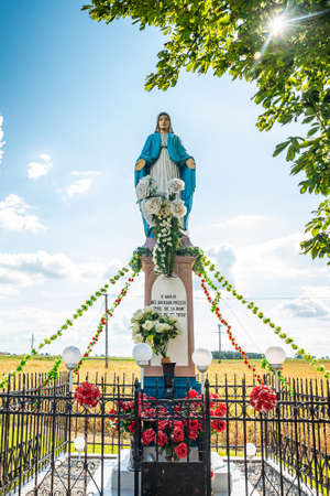 Wloszyca, Poland - August 11, 2021. Religious statue of Virgin Mary by the crossroad in Wloszyca village.のeditorial素材
