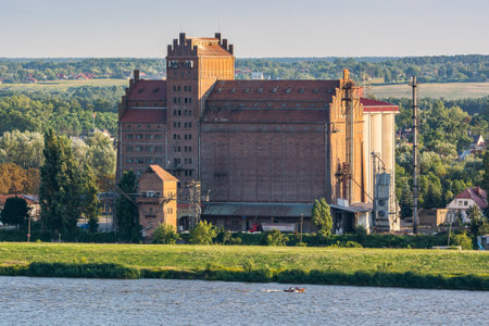 Plock, Poland - August 12, 2021. Old cereal elevator on the shore of Vistula riverのeditorial素材
