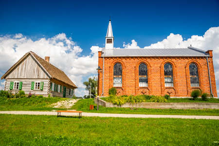 Wiaczemin Polski, Poland - August 12, 2021. Open-air museum of the Vistula settlement - Skansen Osadnictwa Nadwislanskiego - church and schoolのeditorial素材
