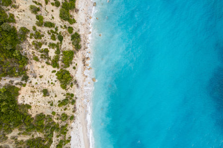 Straight down view on waves on rocky shore by Bunec Beach area in Summer 2022, Albaniaの写真素材