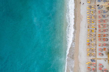 Straight down view on parasols and beach by Bunec Beach area in Summer 2022, Albaniaの写真素材
