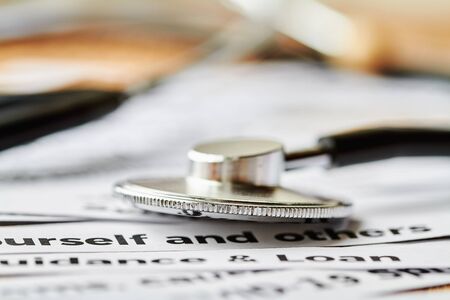 Stethoscope or phonendoscope on the background of newspaper headline clippings. Concept of COVID-19. Closeupの写真素材