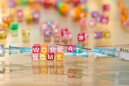 The inscription WORK AT HOME from multi-colored cubes on syringes needles. Concept of protection...