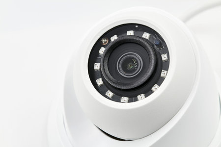 Dome secure camera on light background with motion sensors. Video surveillance camera. Closeup,...