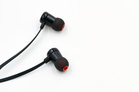 Black earphones lie on white background. Closeupの写真素材