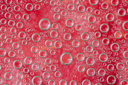 Condensate. Red water drops background. Close-up