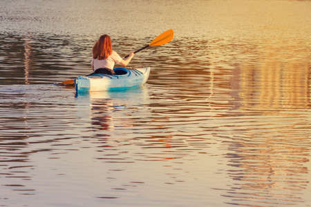 A girl in a blue kayakの写真素材