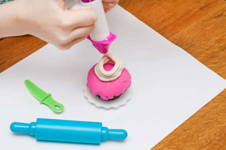 A toy cupcake made by girl using toy cupcake factoryの写真素材