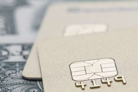 Gold credit cards on the background of the dollar bill. Selective focus, closeupの写真素材