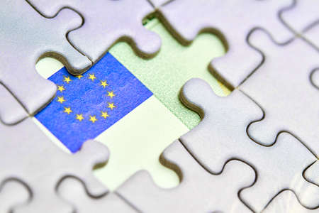 Euro puzzle, business concept of solution. One hundred euro bill and puzzle pieces. Closeup, selective focusの写真素材