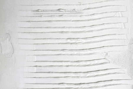 White grooved stucco on wall. Old plaster texture or background. Closeupの写真素材