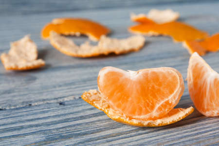 Tangerine slice and zest on wooden backgroundの写真素材
