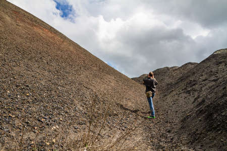 A man in the mountains is taking pictures of the landscapeの写真素材