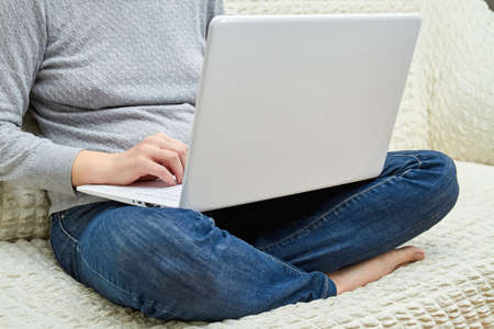 Coronavirus outbreak. Woman working on laptop computer during quarantine. Stay at home, work from home concept. Self isolationの写真素材