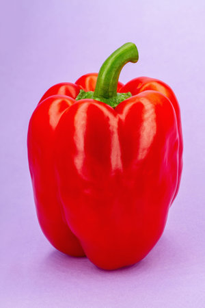 Close-up of sweet red Bell Pepper on a purple background