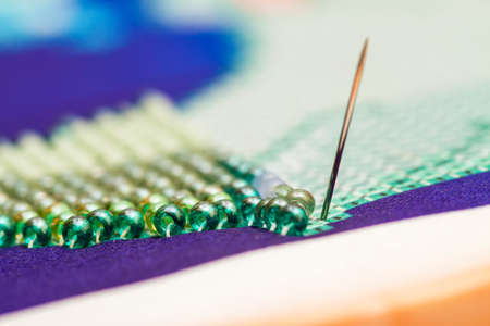 Embroiders with colorful beads. Close-upの写真素材