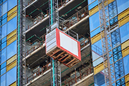 Lift on a glass skyscraper under constructionの写真素材