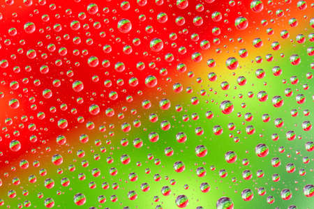 Water drops on green red background. Top view. Closeup.の写真素材