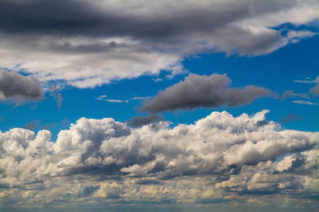 Cloudscape. Blue sky and gray Cumulus cloudsの写真素材