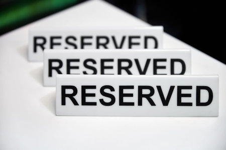 Plastic plaque with the inscription Reserved on the restaurant table