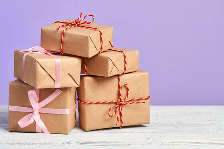 Christmas or New Year gift boxes on wooden surface against a purple background
