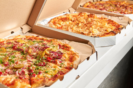 Pizza in open boxes prepared for deliveryの写真素材