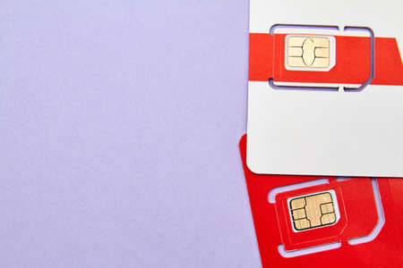 Sim cards for mobile phones on purple backgroundの写真素材