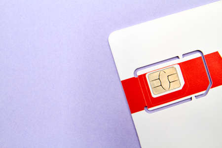 Sim card for mobile phone on purple backgroundの写真素材