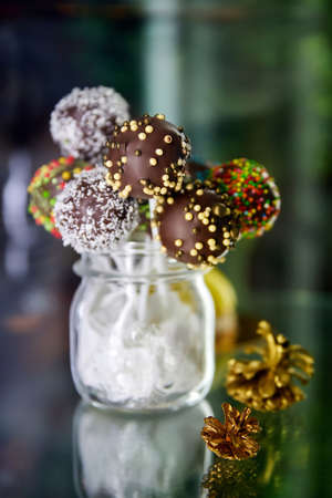 Variety of colorful Chocolate cake pops in a transparent jar. Close-up, selective focusの写真素材