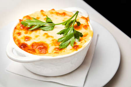 Baked chicken fillet with potatoes and cream cheese sauce. Close-up, selective focusの写真素材